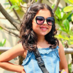 While wearing sunglasses, Aradhya Aanjna poses for a picture.