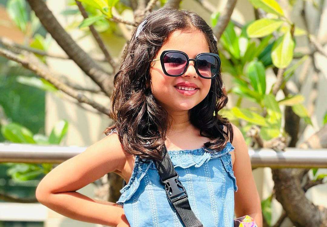 While wearing sunglasses, Aradhya Aanjna poses for a picture.
