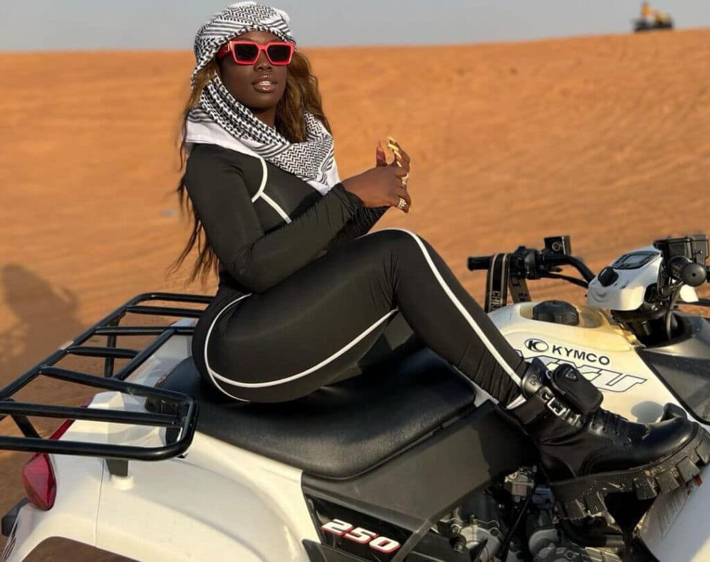 Cire Traore poses for a photograph whilw she is riding a bike - lady biker