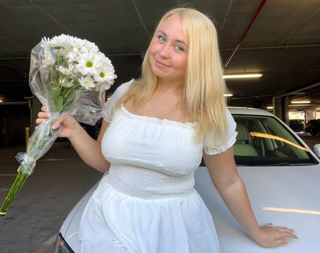 presidentniki Antique Christening Dress, while she is holding flowers