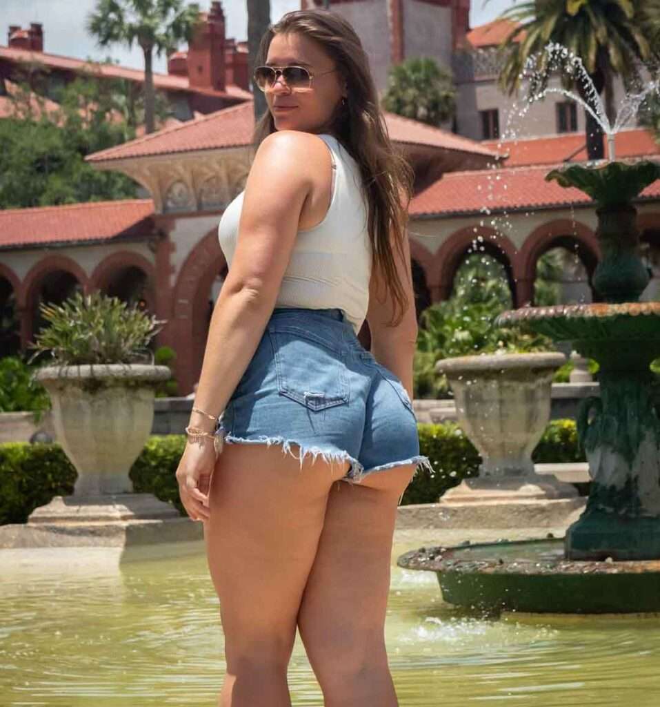 Allie Compton is shown in a picture posing while having best golf shorts and Milani Seamless Ribbed Bodysuit