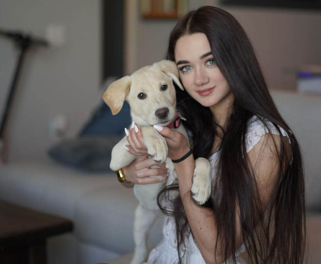 Iryna Frantsuz holding Labrador Retriever Puppy in photoshoot