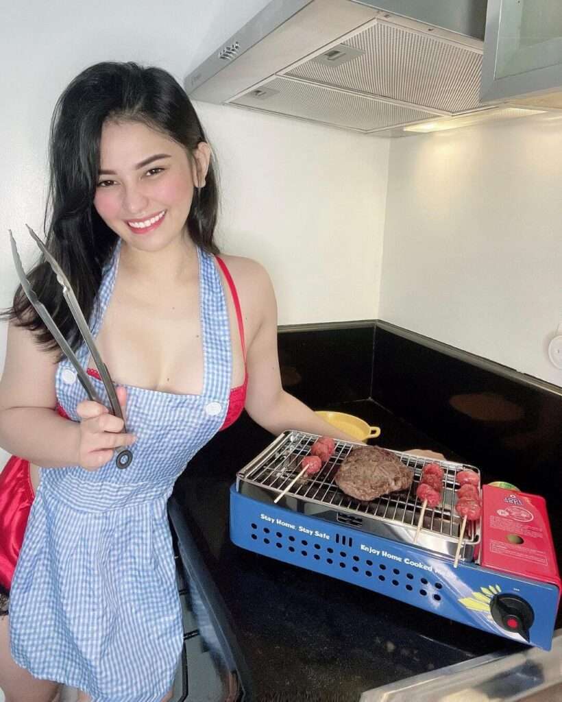 Kate Gonzales wearing night store pyjamas while she is cooking