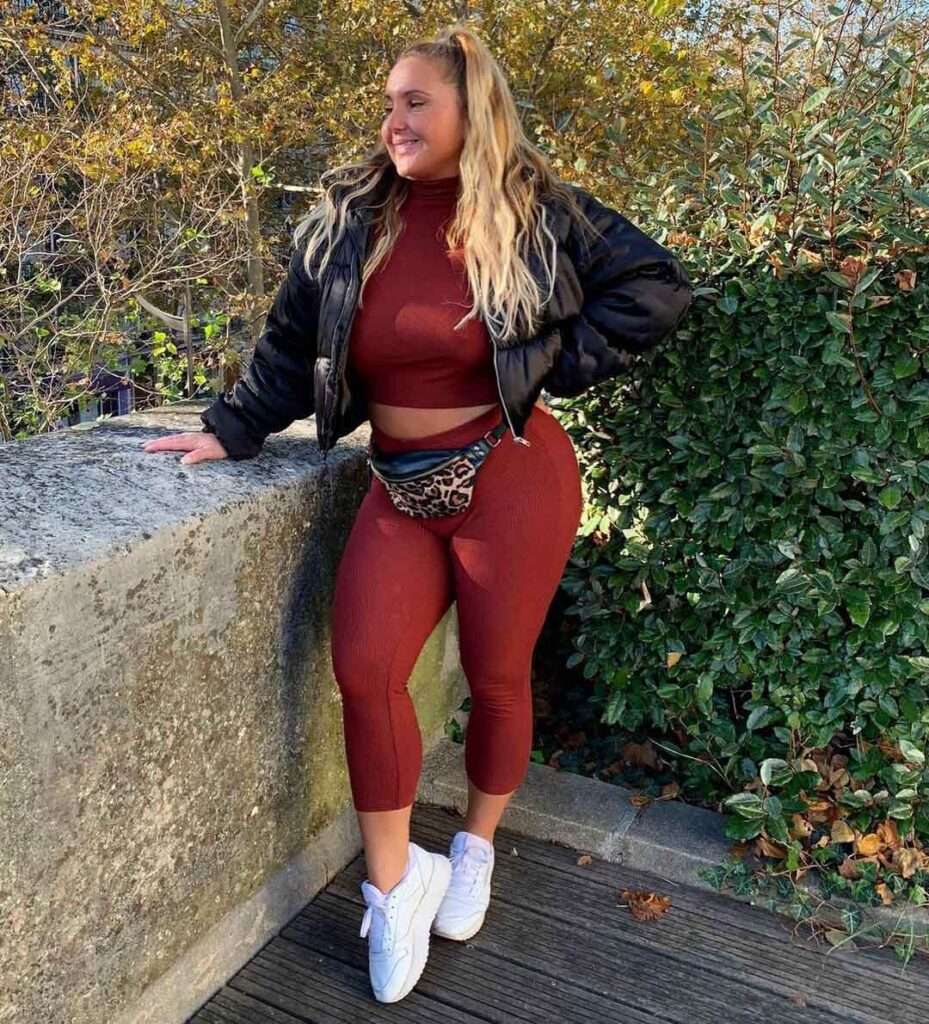 Loli Fit poses for a photograph while she is wearing a leggings and top set and columbia jacket