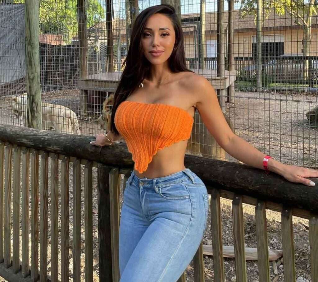 Melissa Alvarez poses for a photograph while wearing crop top with jeans