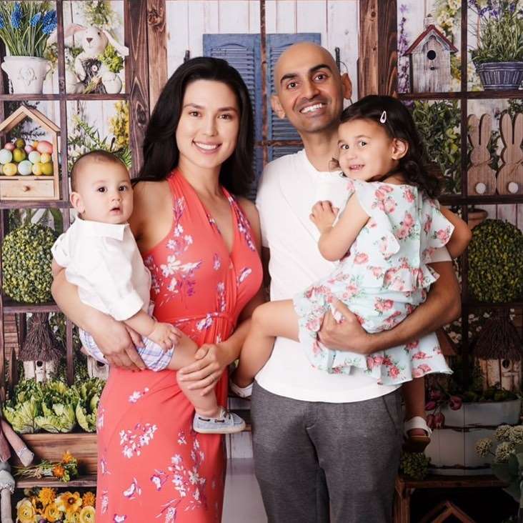 Neil Patel with his wife and kids,wearing a white t-shirt with black trouser