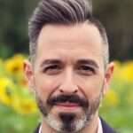 Rand Fishkin smiling towards the camera while taking picture