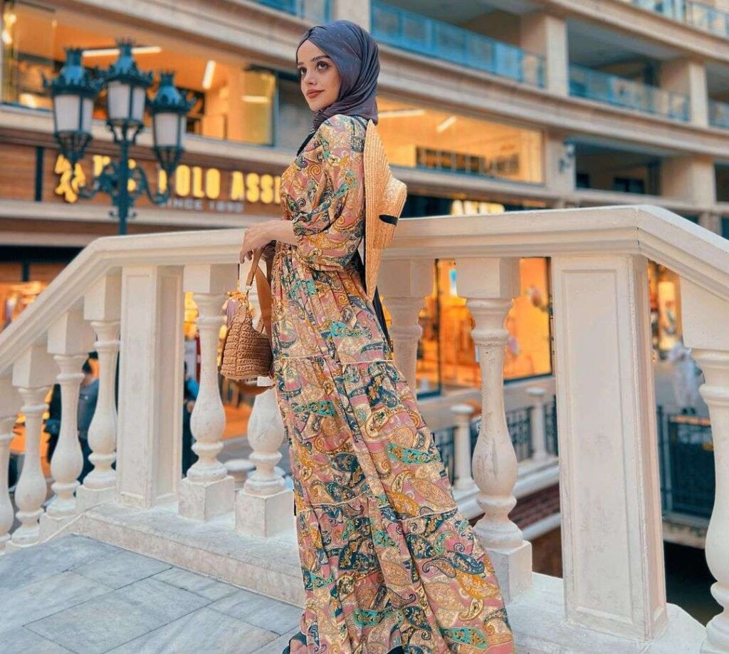 Abir-El-Saghir in a reformation style dress while poses for a picture