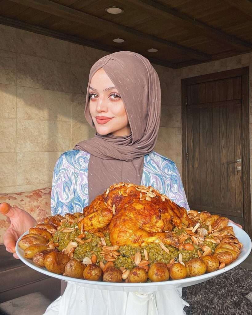 Abir-El-Saghir in a reformation style dress while showing her cooked delicious food