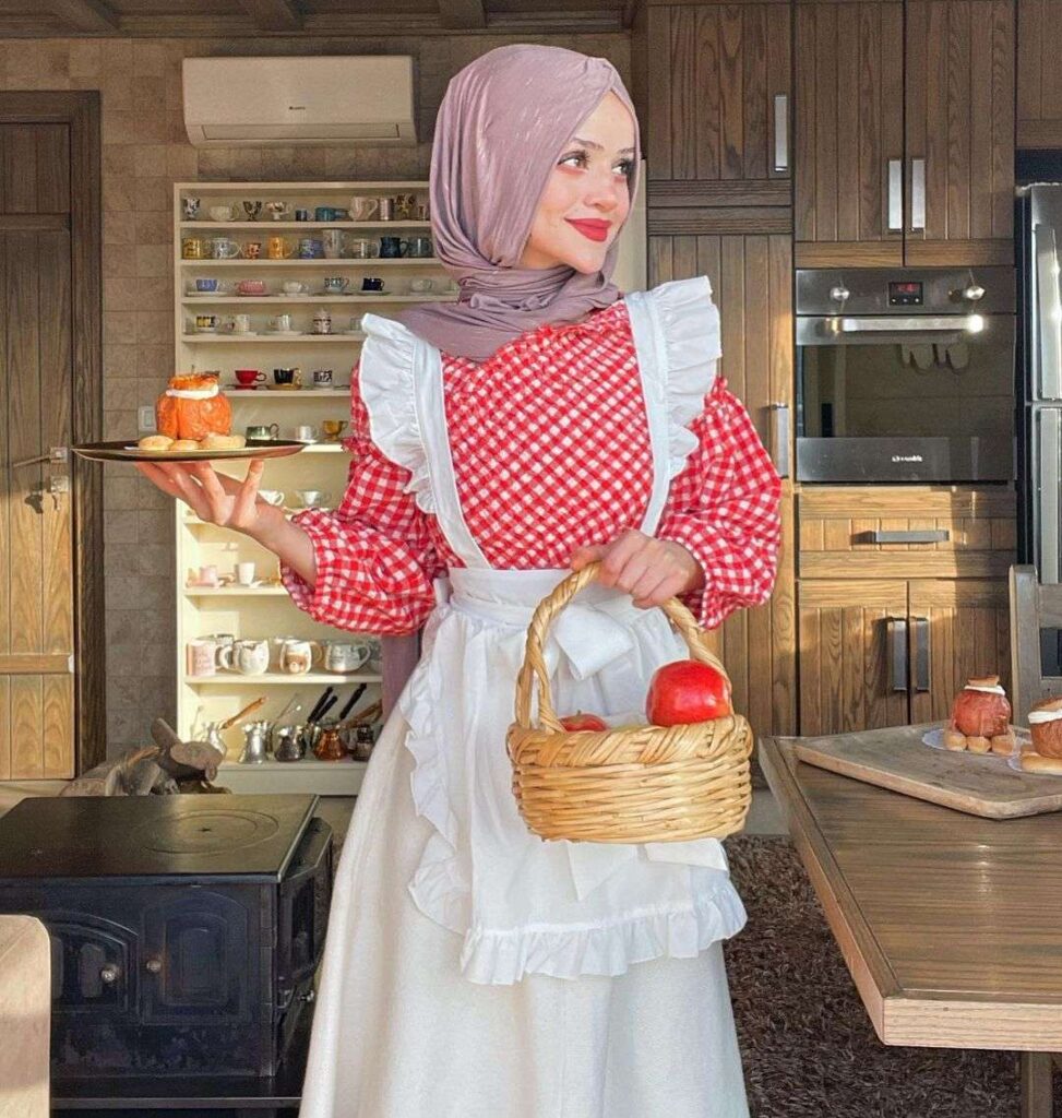 Abir-El-Saghir in a red and white outfit while holding her cooked food in her hand