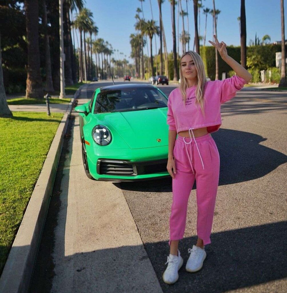 Angelina Dimova in a pink track suit pair with white jogger while poses for a picture