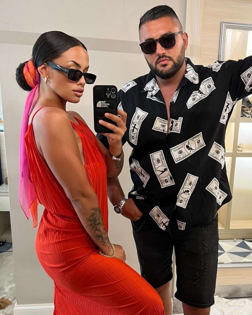 Antelainta-DH. in a red reformation maxi dress while taking selfie with her boy friend in the front of mirror