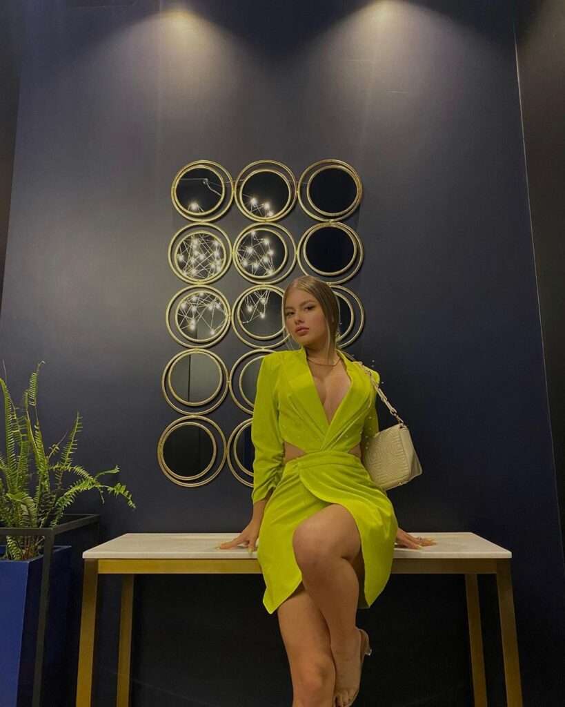 Domenica Briones in a yellow green mix shade outfit pair with a brown beg
