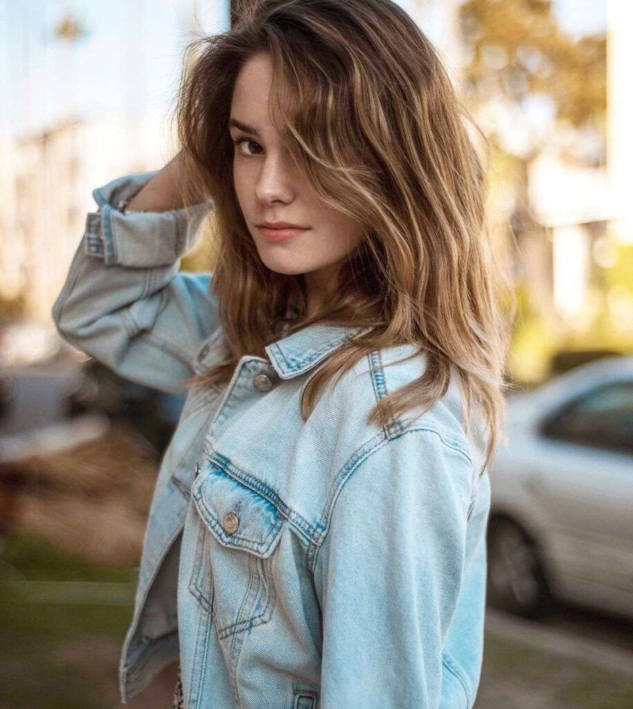 Makenzie Raine in the denim jacket while poses for a photo