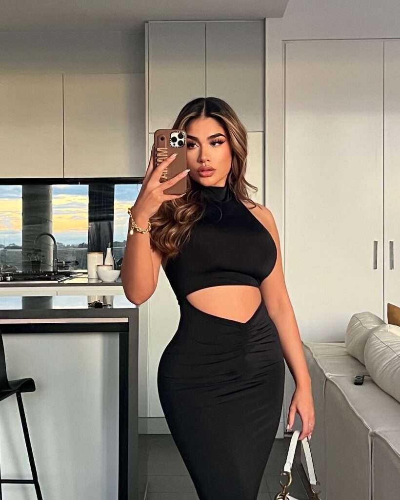 Maria Perez is taking mirror selfie in a beautiful black cropped maxi