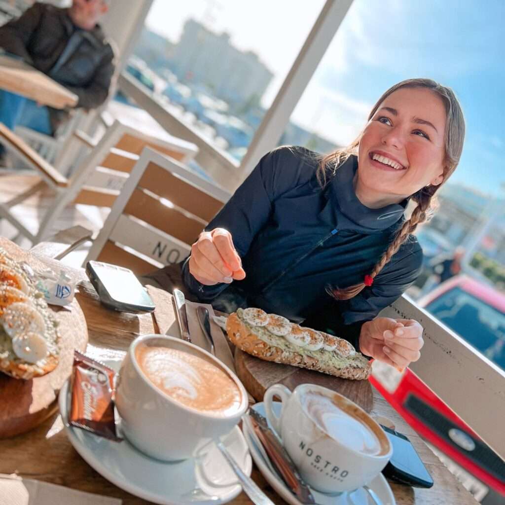 Puck Moonen in a black high neck shirt while taking her breakfast