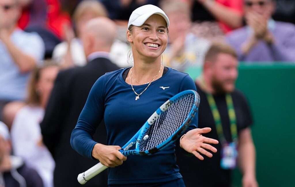 Yulia Putintseva in the navi blue t-shirt and shorts holding a racket in her hand