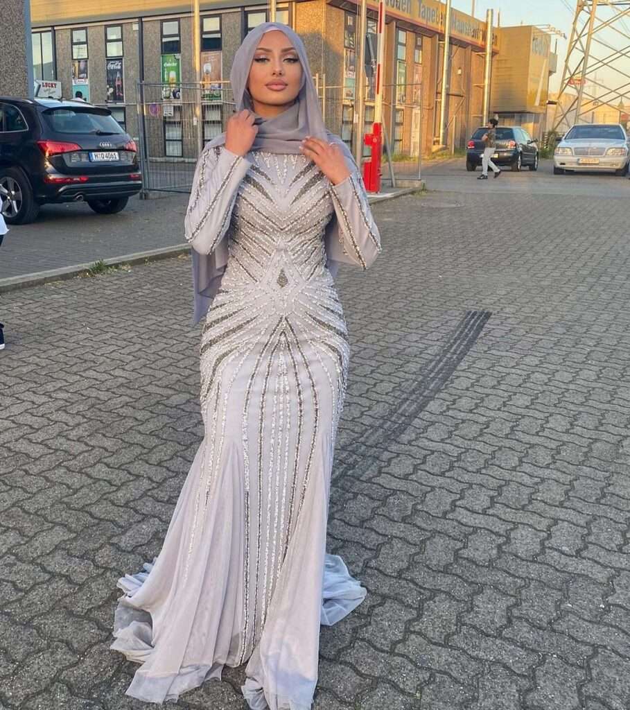 IIso Abyy is advertising her outfit while wearing a white beautiful maxi with a hijab. looking gorgeous.