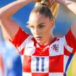 Ana Maria Marković in a red and white contract t-shirt while setting her hairs, a random click
