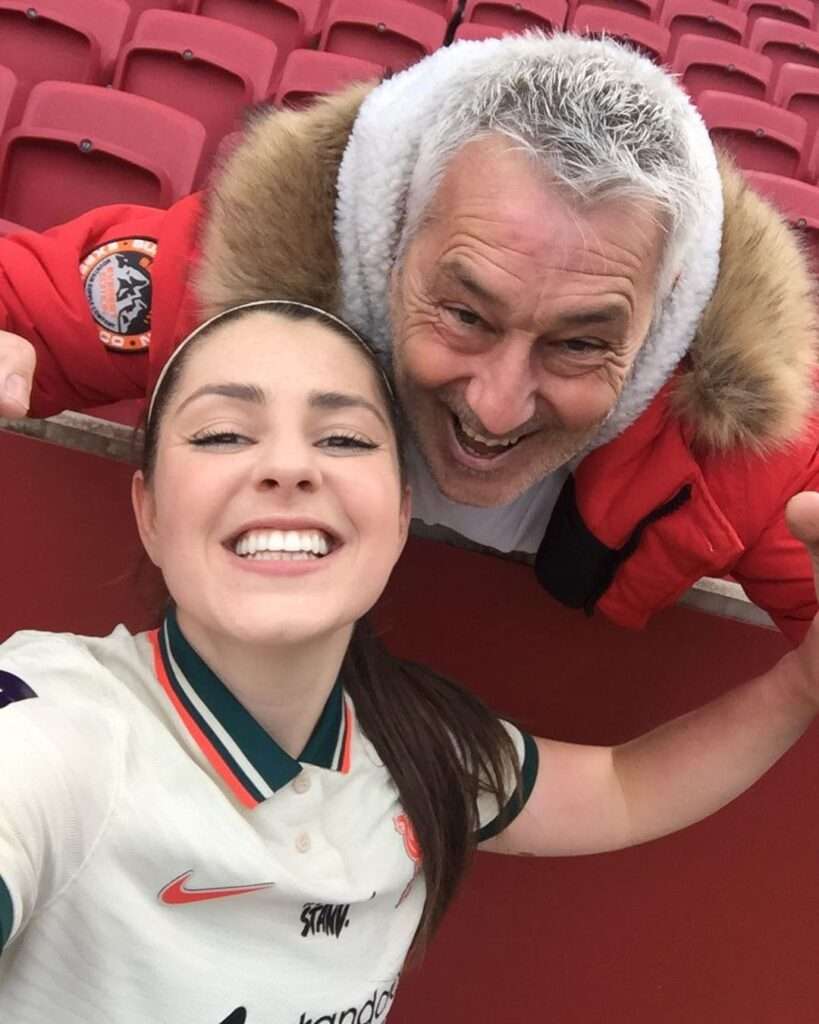 Carla Humphrey in a white shirt while taking picture with her dad