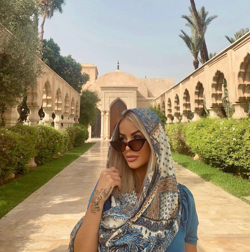 Mina Erika is wearing a printed scarf pair with goggles while visiting a mosque