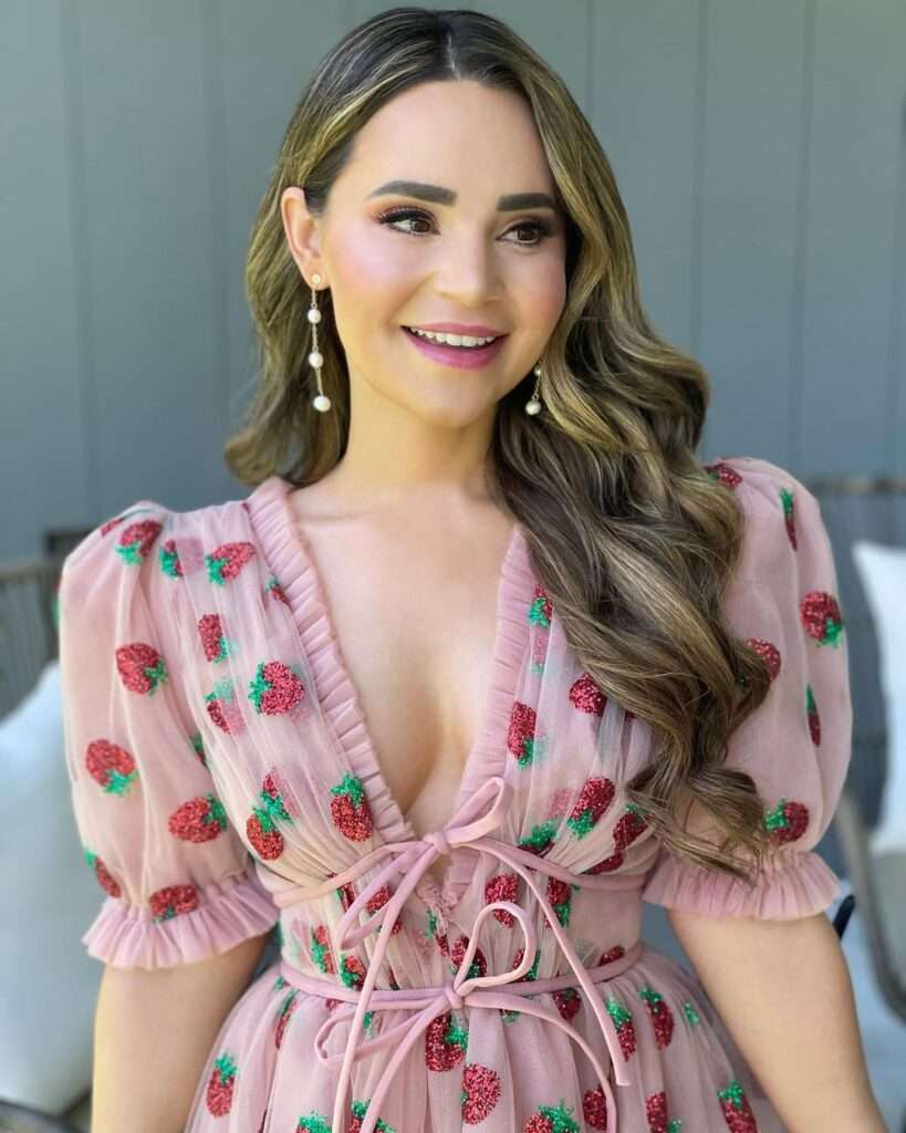Rosanna Pansino is just posing for a picture in a top tank looking cute.