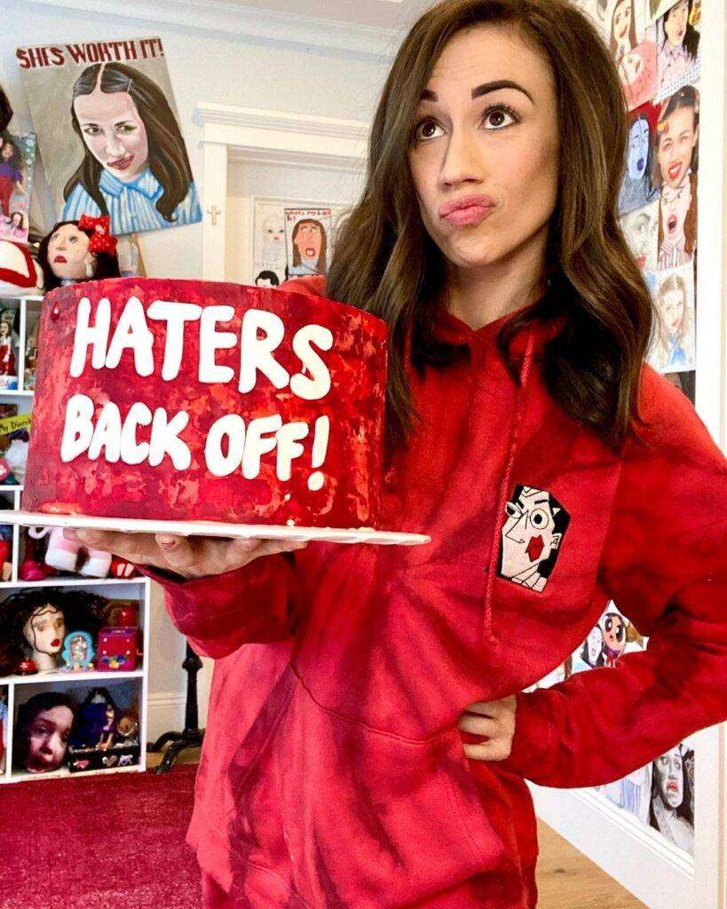 Collene Ballinger has made a Haters Back Off cake and showing and promoting her show ratings.