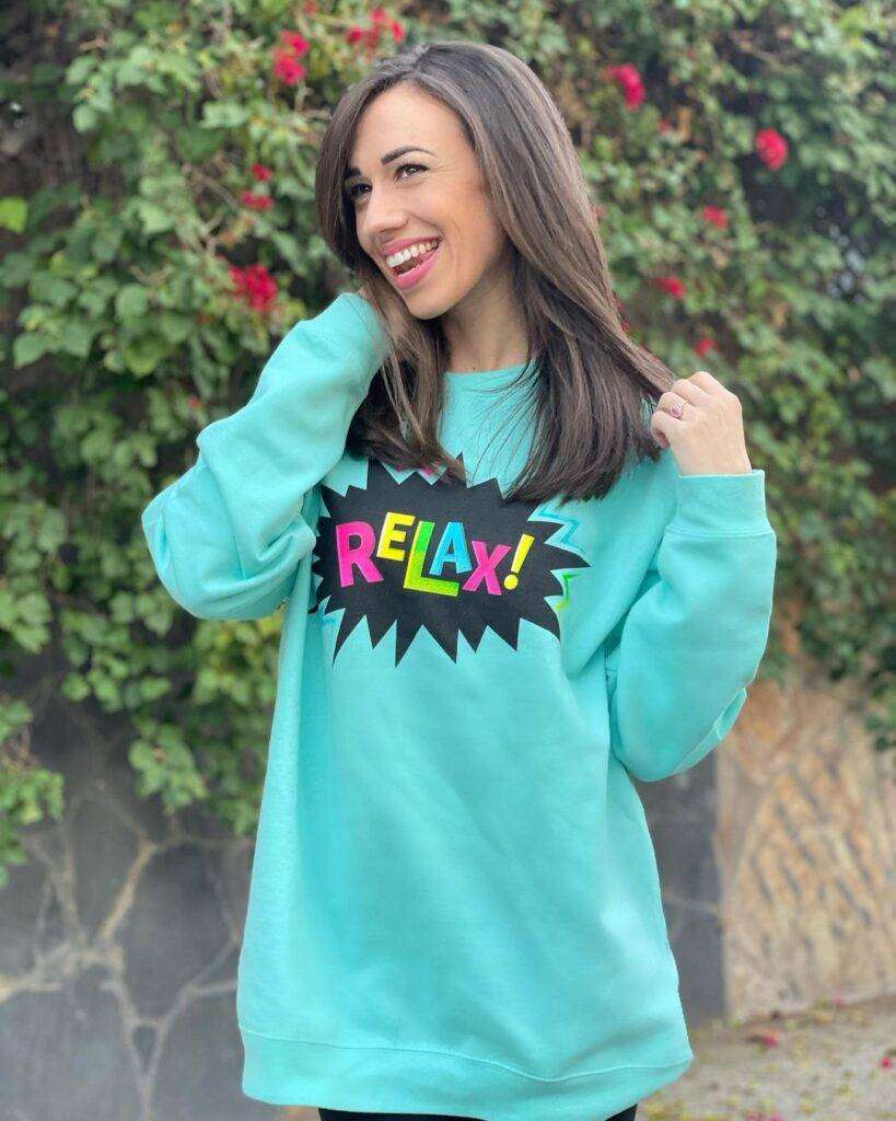 Colleen Ballinger is just posing cool for a picture and giving a cute smile while wearing a pant and shirt.