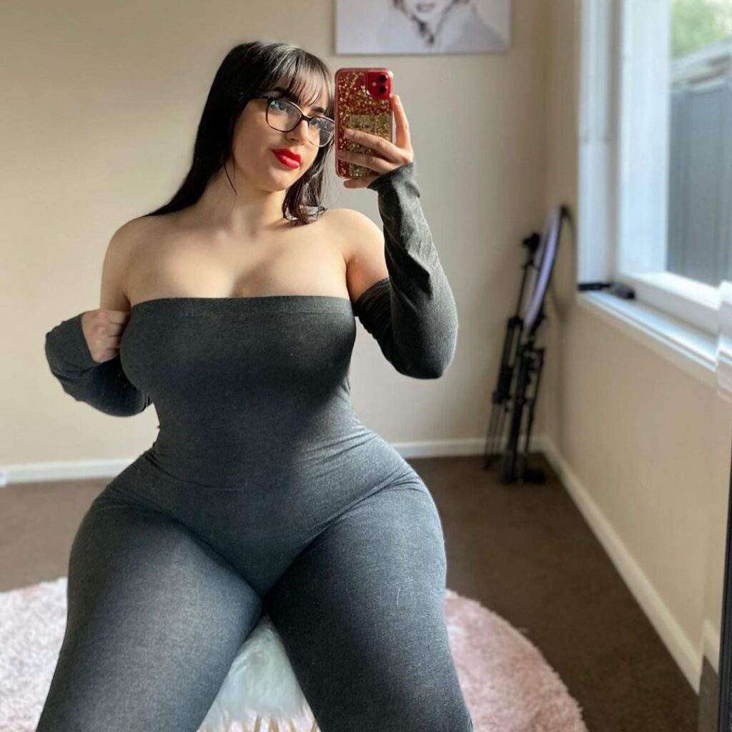 Amiliasoforiegn is just taking mirror selfie and showing her curvy figure while wearing a legging full suit.