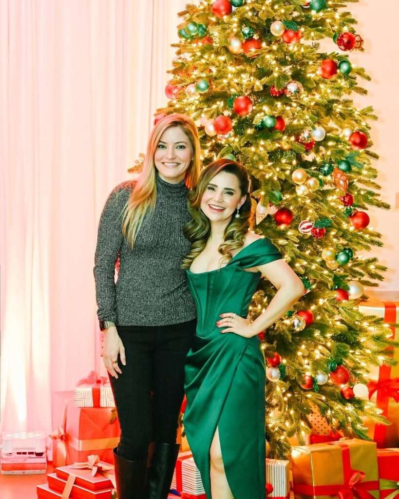 iJustine is enjoying Christmas party with her friend Rossano looking happy.