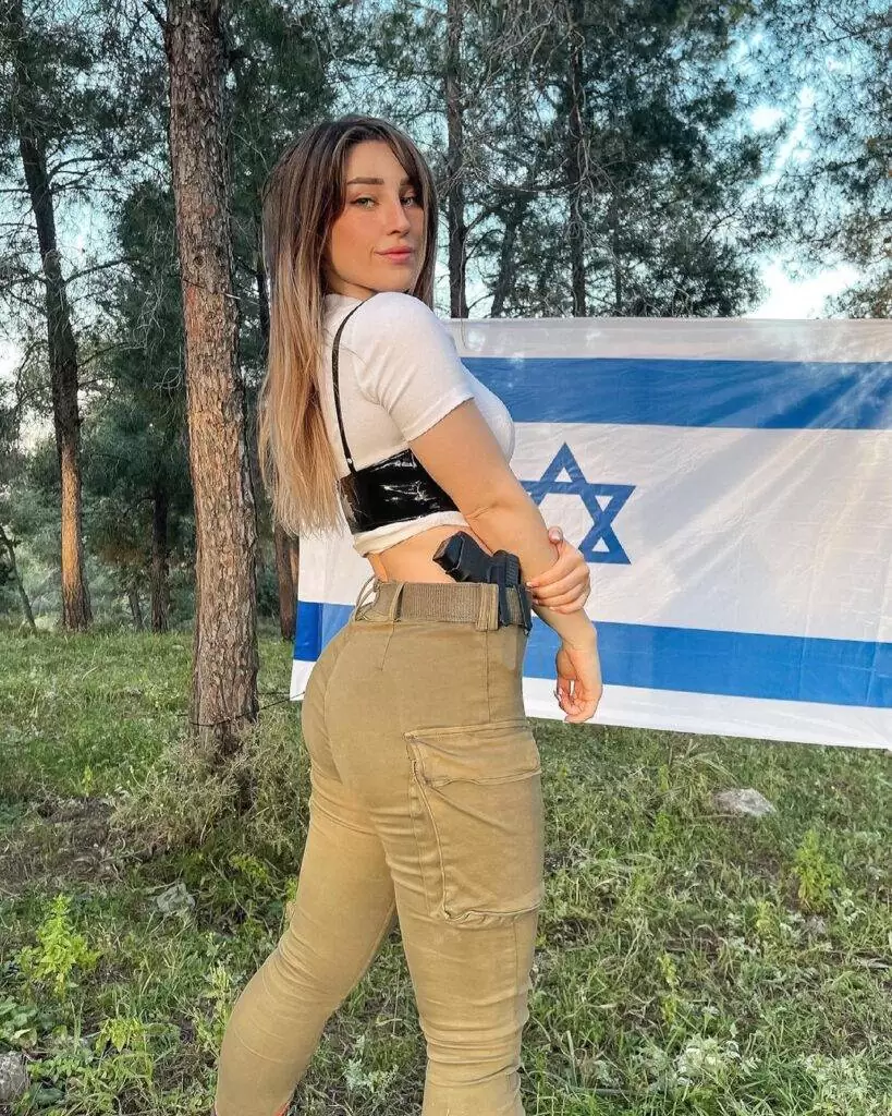 Natalia Fadeev in a white crop shirt pair with brown pants while showing her back side pose towards camera
