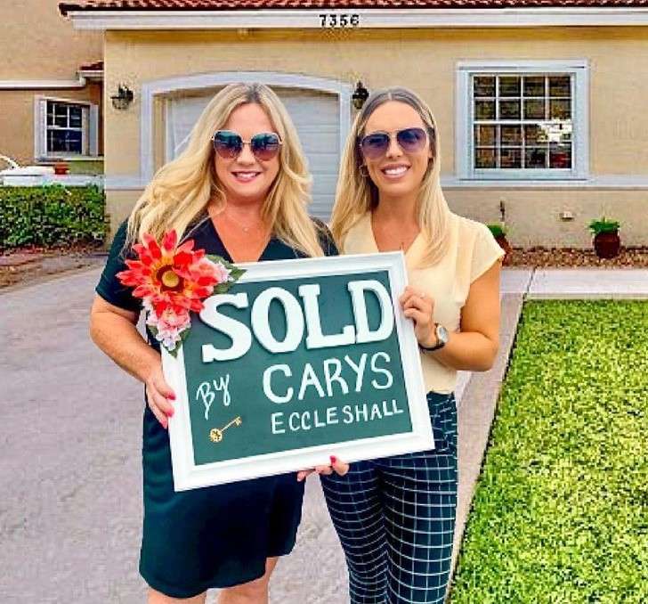 Carys Eccleshall is after selling a home and is standing with her client and looking happy for her sucess.