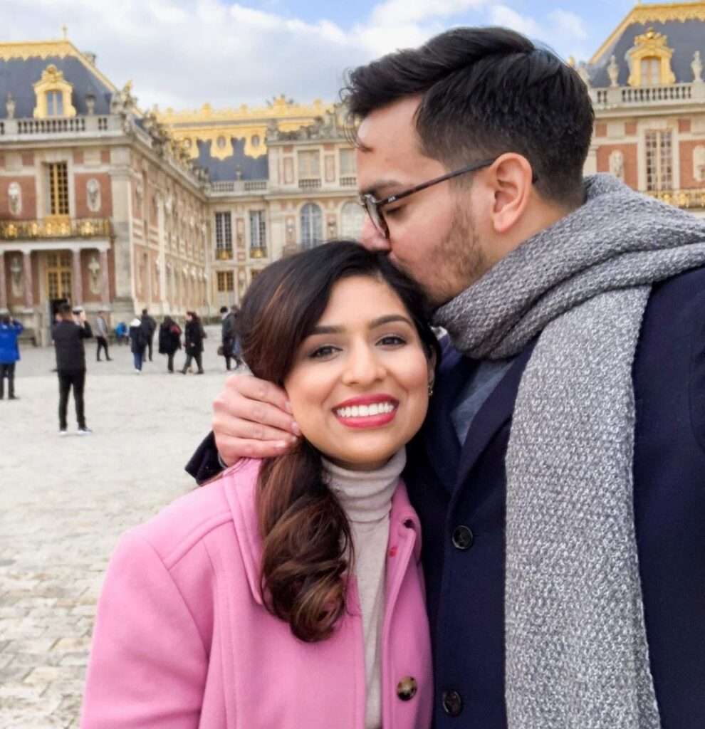 Dr. Muneeb Shah in the navi blue coat with grey muffler while kissing on her wife head