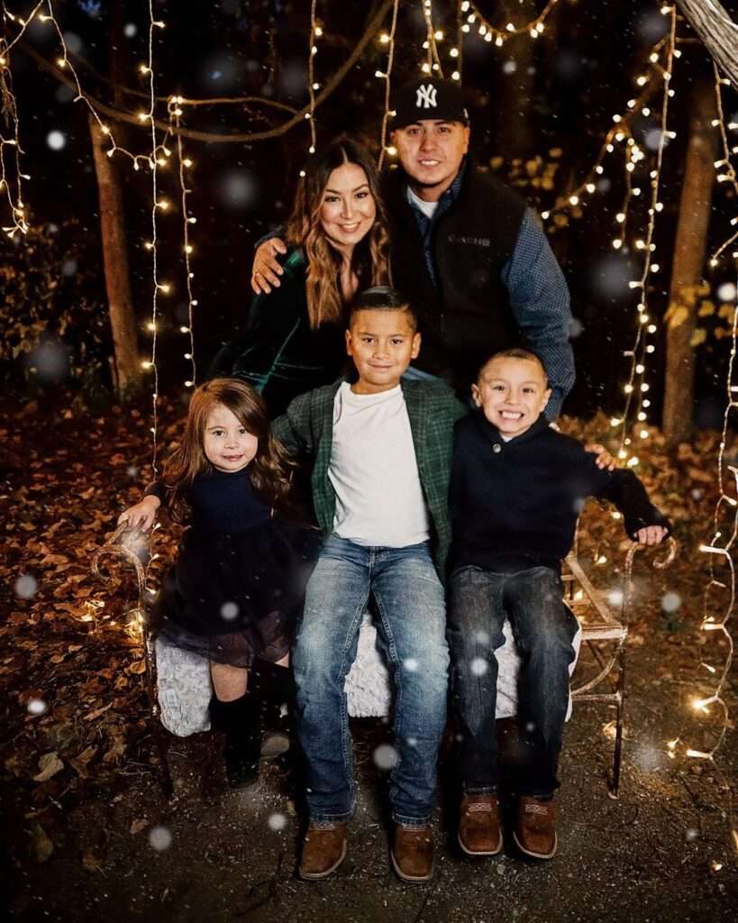 Elizabeth Salazarrr is posing for a picture with her family including 2 sons and one daughter and they are looking happy together,