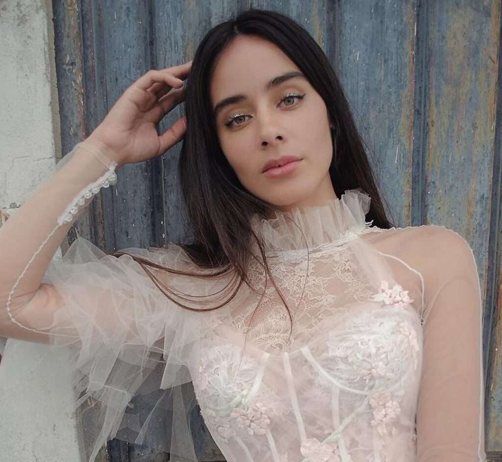Esmeralda Pimentel in the beautiful white fancy outfit while poses for a picture to take a picture