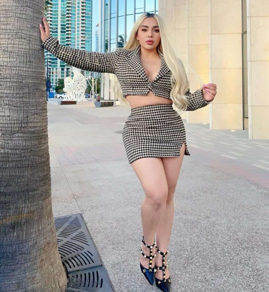 Leslie Aguilar in the sexy printed black crop top pair with mini skirt and black shoes while looking towards camera