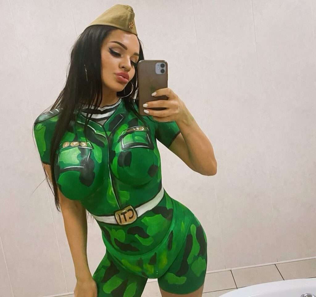 Lilya Volkova in the green jumpsuit while taking a picture in the front of mirror