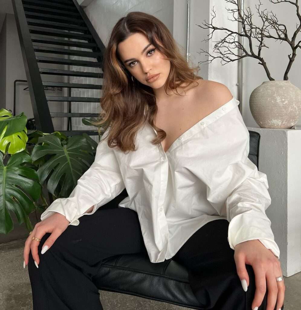 Maribel Sancia Todt in the white dress shirt pair with black pants while looking towards camera for a picture