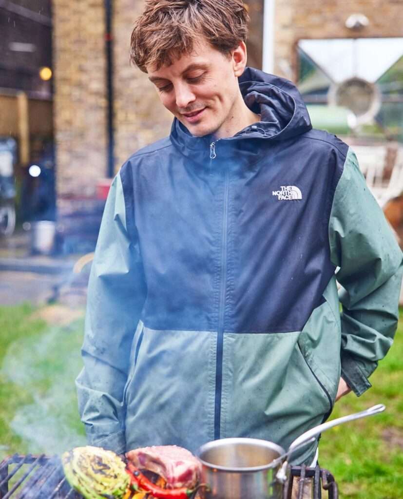 Thomas Straker is making lunch and is posing for a picture while smiling.