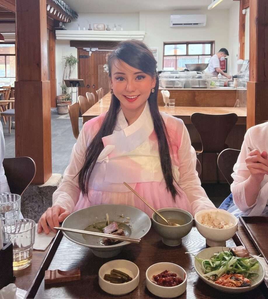 Sally Yeo in the sexy pink dress while taking a meal in the restaurant