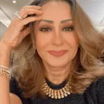 Hala Kazim in the black shirt pair with chunky necklace and bracelet while taking a selfie