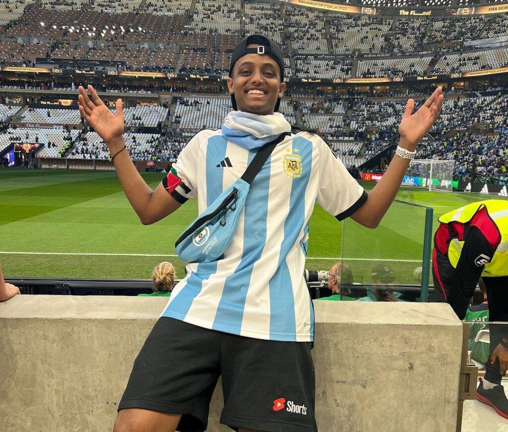 Hassan Suleiman in the Argentina football costume while smiling towards camera