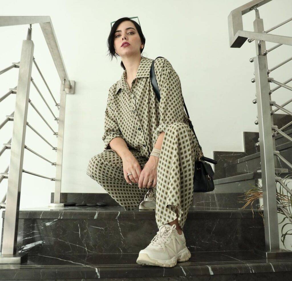  Azza Zarour  in the beautiful pastel shade outfit while sitting on the stairs and looking towards camera