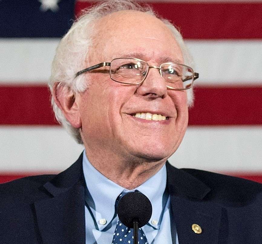 Bernie Sanders is smiling and is ready to address with his nation.