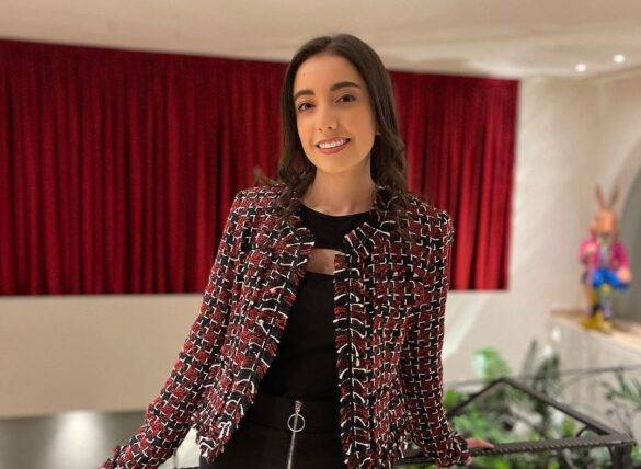Joanna Bou Nasr in the black bodycon pair with printed jacket and smiling towards camera
