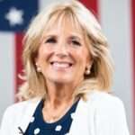 Jill Biden is here attending meeting and is smiling and posing for a picture.