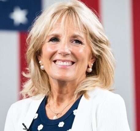 Jill Biden is here attending meeting and is smiling and posing for a picture.