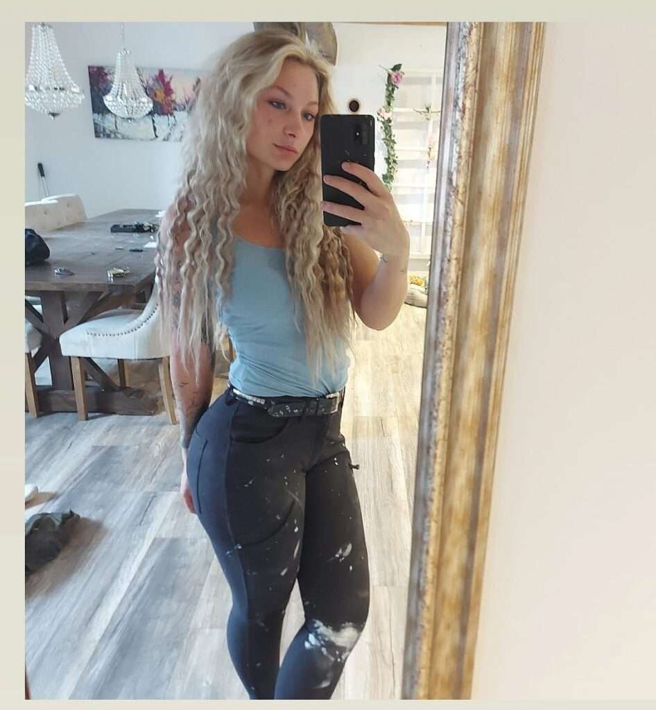 Johanna Juhlin in the blue t-shirt pair with blue jeans while taking a photo in the front of mirror