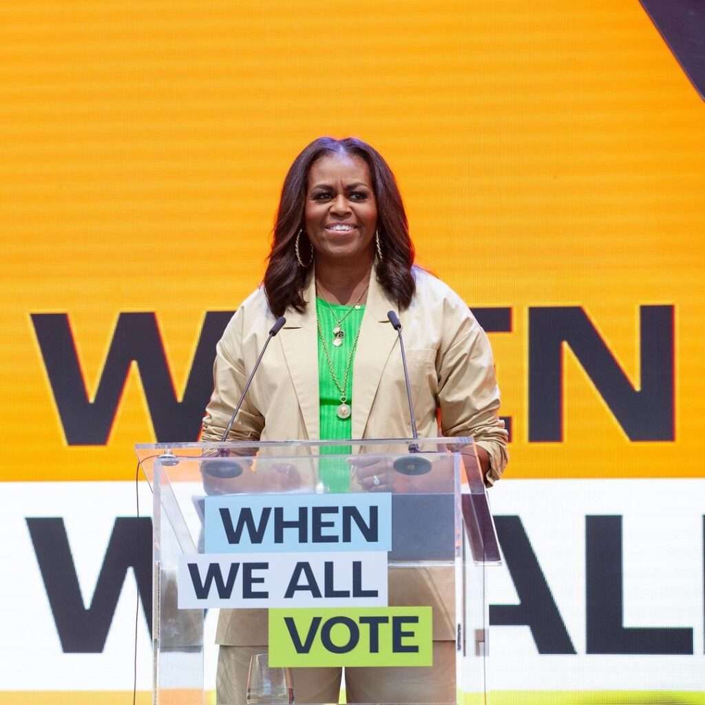 Michelle Obama is smiling and Addressing to her nation about importance of votes.