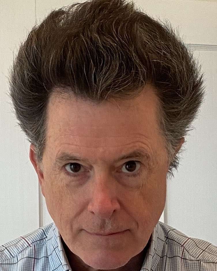 Stephen Colbert is looking funny as he is a comedian and he changes his hairstyle.